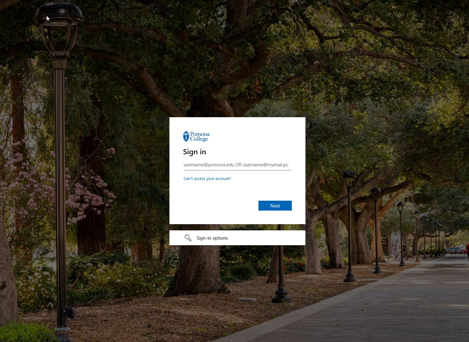 The Pomona College sign-in page shown on a photograph of campus. A dialogue box asks for username@pomona.edu or username@mymail.pomona.edu, with a Next button, a link for people who cannot access their account, and a sign-in options link.